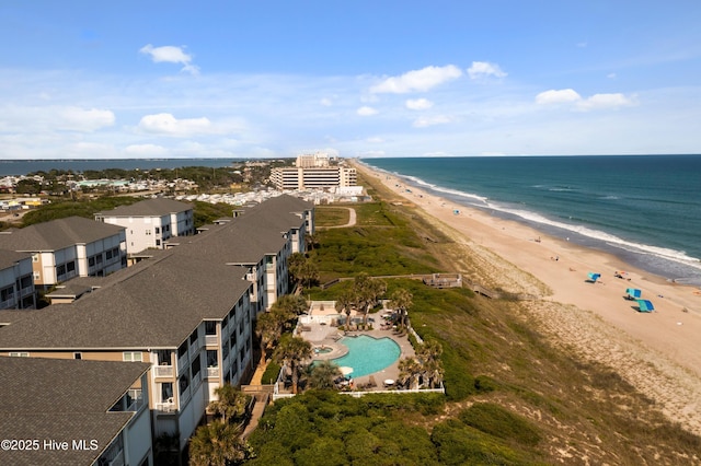 aerial view of property's location featuring expansive beach and a pool