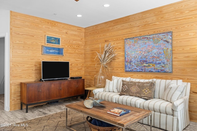 living area with wood finished floors, recessed lighting, wood walls, and ceiling fan