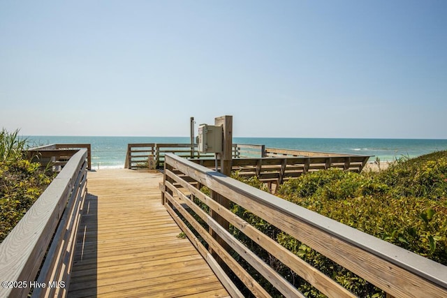 view of home's community featuring view of water and beach