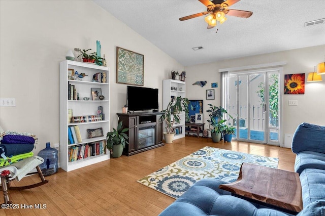 living area featuring ceiling fan, wood finished floors, and visible vents