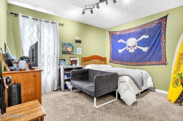 carpeted bedroom featuring a textured ceiling