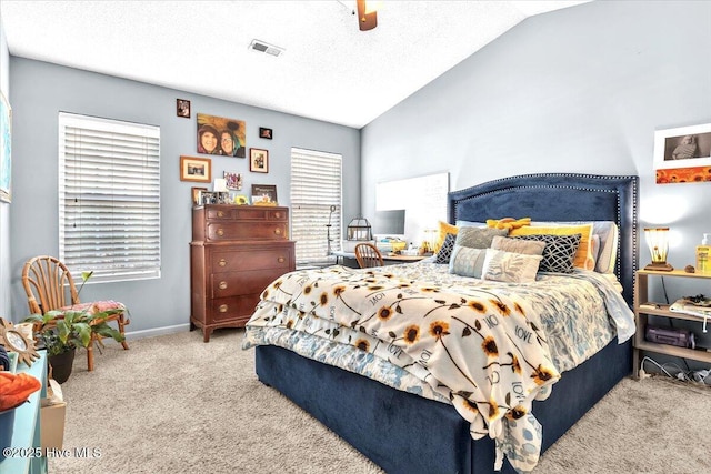 carpeted bedroom featuring a ceiling fan, baseboards, visible vents, and lofted ceiling