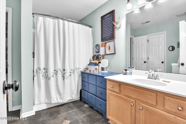 bathroom featuring vanity, a shower with curtain, a textured ceiling, and visible vents