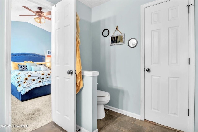 bathroom featuring ensuite bathroom, baseboards, ceiling fan, and toilet