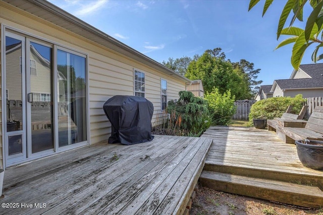 deck featuring grilling area and fence
