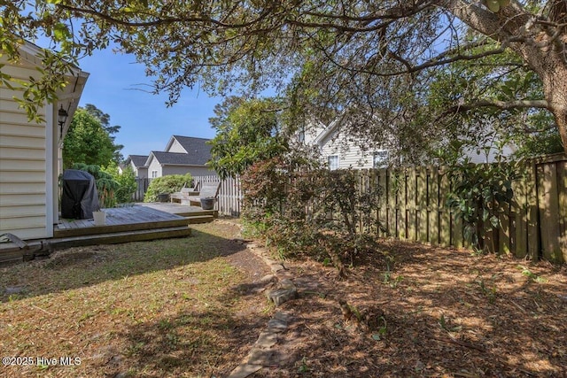 view of yard featuring a fenced backyard and a deck