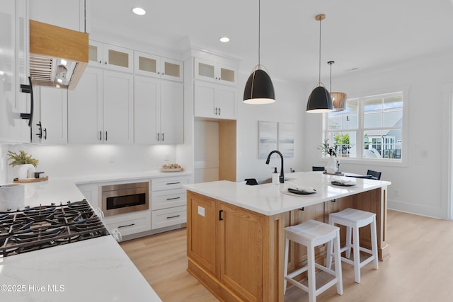 316 Lightning Bug Ln, Holly Ridge, NC 28445 - kitchen with glass insert cabinets, recessed lighting, light countertops, a sink, and light wood-style flooring