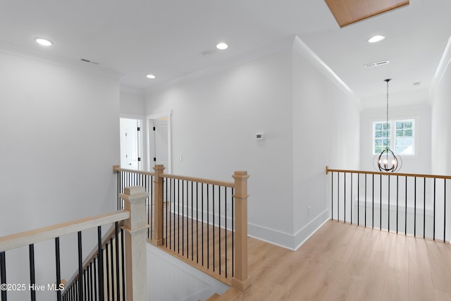 316 Lightning Bug Ln, Holly Ridge, NC 28445 - hall with visible vents, an upstairs landing, wood finished floors, a chandelier, and recessed lighting