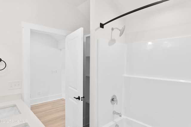 316 Lightning Bug Ln, Holly Ridge, NC 28445 - full bathroom with wood finished floors, a sink, baseboards, and bathtub / shower combination