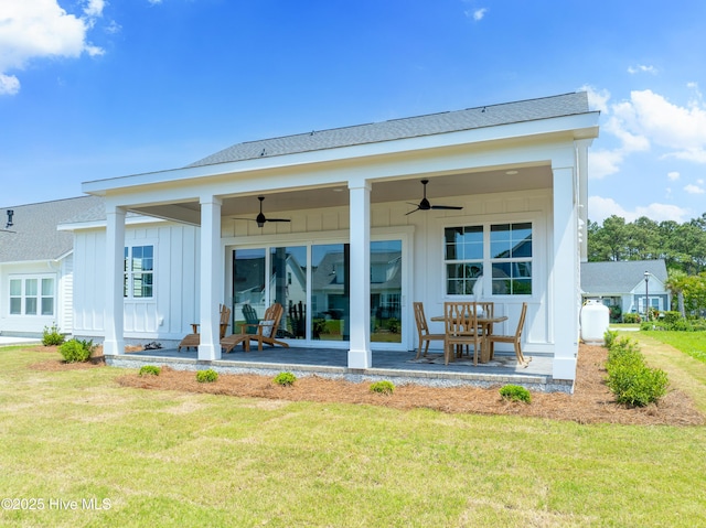 316 Lightning Bug Ln, Holly Ridge, NC 28445 - rear view of house featuring board and batten siding, ceiling fan, a yard, and a patio area