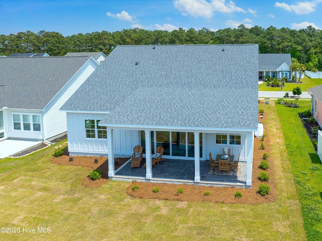 316 Lightning Bug Ln, Holly Ridge, NC 28445 - back of property featuring board and batten siding, a yard, a patio area, and roof with shingles