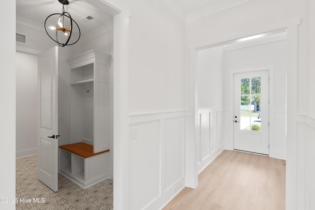 316 Lightning Bug Ln, Holly Ridge, NC 28445 - mudroom featuring visible vents, a wainscoted wall, light wood finished floors, an inviting chandelier, and a decorative wall