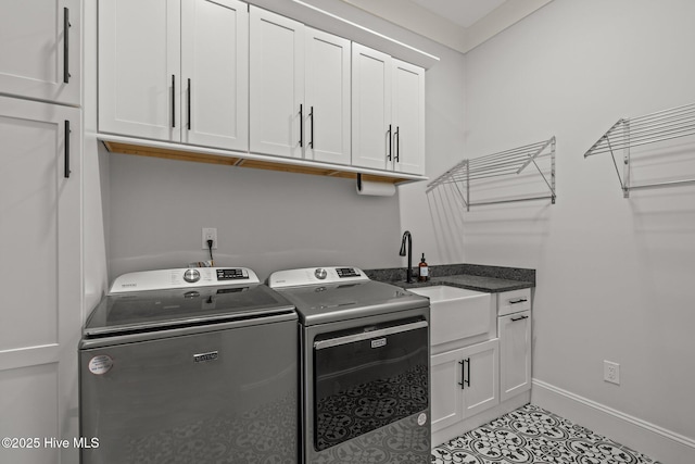 clothes washing area featuring baseboards, cabinet space, independent washer and dryer, and light tile patterned floors