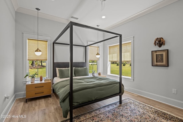 bedroom with baseboards, light wood-style flooring, and visible vents