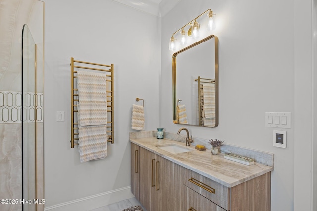 bathroom with baseboards, radiator heating unit, and vanity