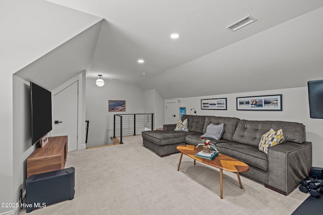 carpeted living area with visible vents, recessed lighting, and vaulted ceiling