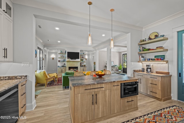 kitchen with crown molding, a warm lit fireplace, open shelves, light wood-style floors, and a kitchen island