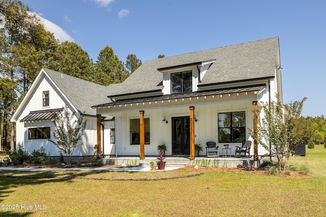 modern farmhouse with a porch, board and batten siding, and roof with shingles