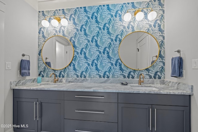 full bathroom featuring double vanity, a sink, and wallpapered walls