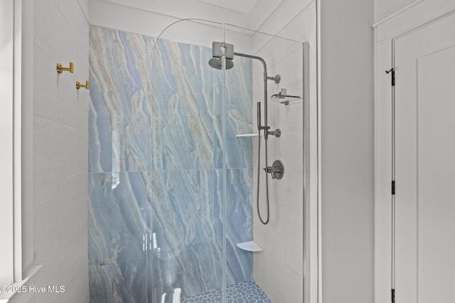 bathroom with a marble finish shower
