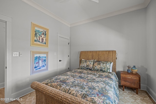 bedroom with baseboards and ornamental molding