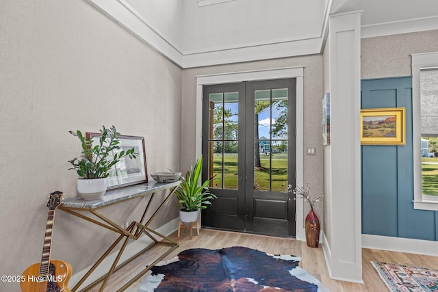 interior space with french doors, baseboards, and wood finished floors