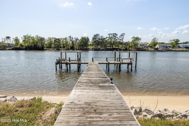view of dock with boat lift and a water view