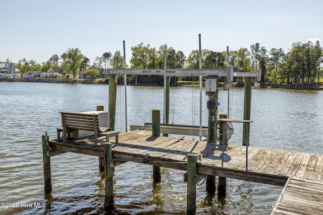 view of dock with boat lift and a water view