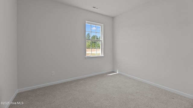 carpeted empty room with baseboards and visible vents