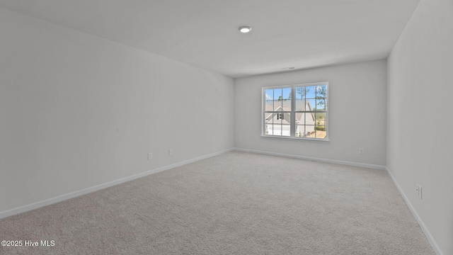 empty room with baseboards and carpet flooring