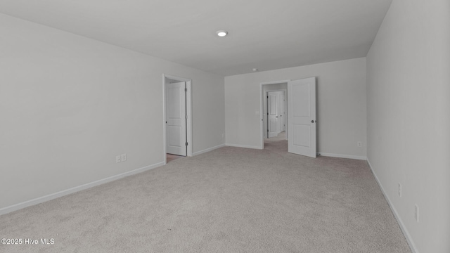 unfurnished bedroom with carpet floors and baseboards