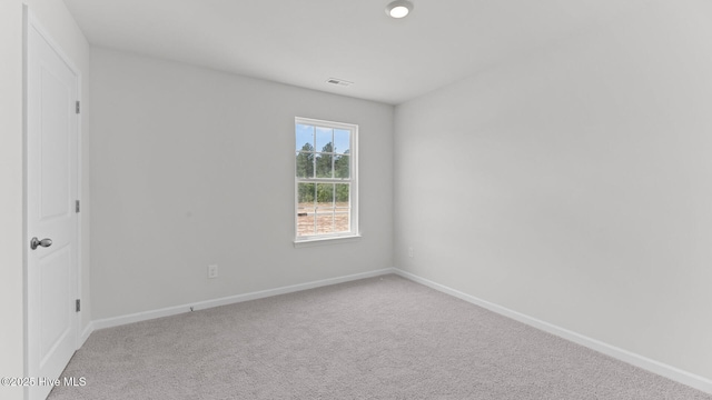 carpeted empty room with baseboards and visible vents