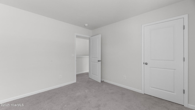 unfurnished bedroom with baseboards and carpet flooring