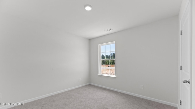 unfurnished room featuring baseboards, carpet flooring, and visible vents