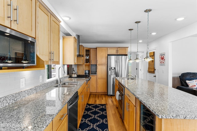 408 Dolphin St, Sunset Beach, NC 28468 - kitchen featuring a large island, a sink, beverage cooler, stainless steel appliances, and light wood-style flooring