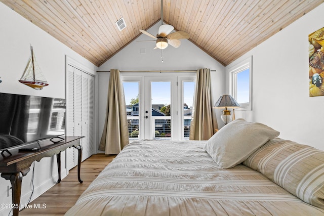 408 Dolphin St, Sunset Beach, NC 28468 - bedroom featuring access to exterior, french doors, wood finished floors, vaulted ceiling, and visible vents