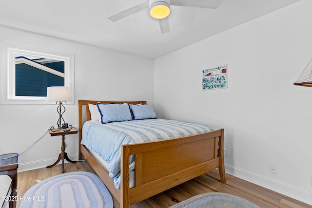 408 Dolphin St, Sunset Beach, NC 28468 - bedroom featuring baseboards, ceiling fan, and wood finished floors