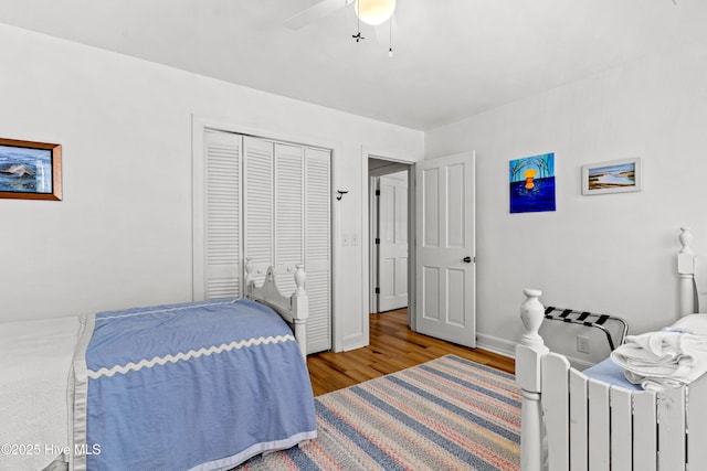 408 Dolphin St, Sunset Beach, NC 28468 - bedroom with baseboards, a ceiling fan, a closet, and wood finished floors