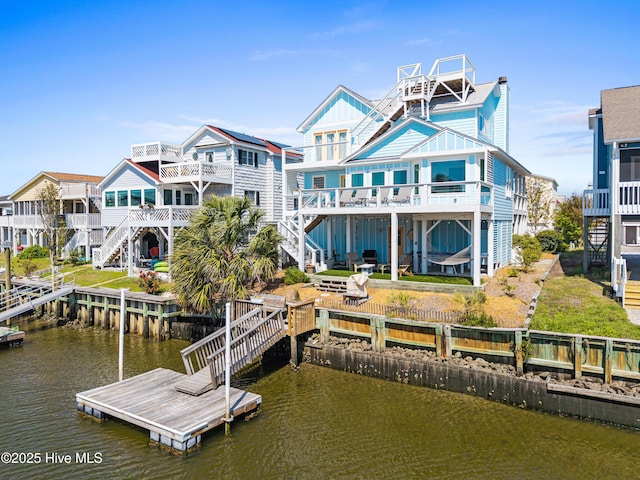 408 Dolphin St, Sunset Beach, NC 28468 - rear view of property featuring board and batten siding, a deck with water view, and stairway