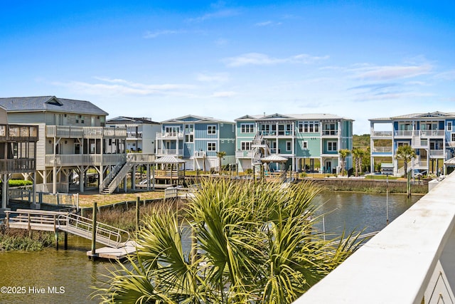 408 Dolphin St, Sunset Beach, NC 28468 - view of dock featuring a residential view and a water view