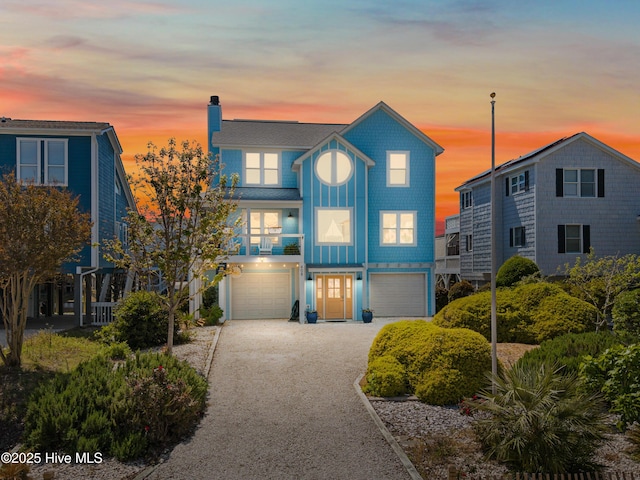 408 Dolphin St, Sunset Beach, NC 28468 - view of front of property featuring a chimney, an attached garage, and driveway