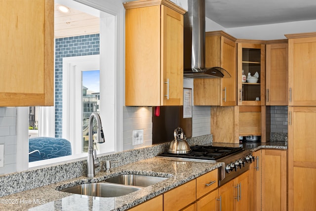 408 Dolphin St, Sunset Beach, NC 28468 - kitchen with decorative backsplash, wall chimney exhaust hood, light stone counters, a sink, and stainless steel gas stovetop