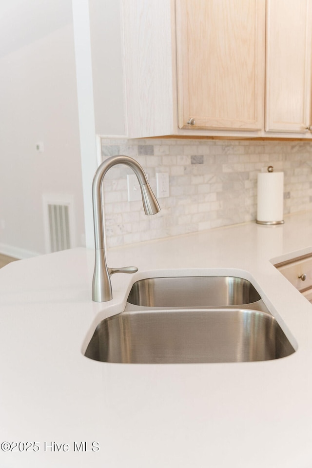135 Live Oak Dr, Leland, NC 28451 - room details with light countertops, light brown cabinetry, and a sink
