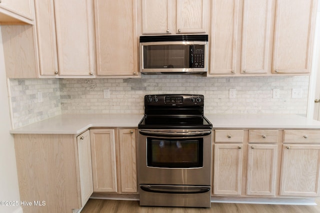 135 Live Oak Dr, Leland, NC 28451 - kitchen featuring backsplash, light countertops, stainless steel appliances, and light brown cabinets