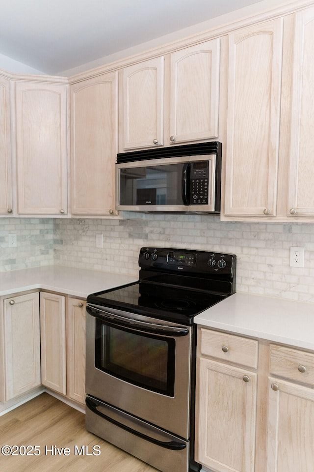 135 Live Oak Dr, Leland, NC 28451 - kitchen featuring light countertops, appliances with stainless steel finishes, light brown cabinets, and backsplash