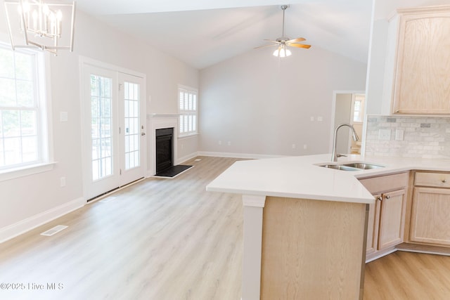 135 Live Oak Dr, Leland, NC 28451 - kitchen with light brown cabinetry, visible vents, a sink, open floor plan, and light wood-type flooring