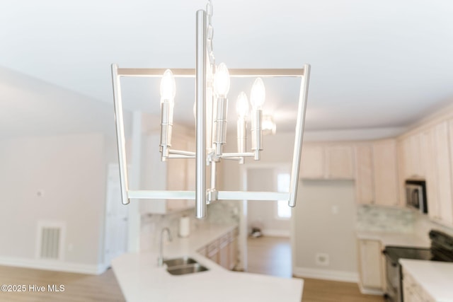 135 Live Oak Dr, Leland, NC 28451 - room details with light countertops, electric range oven, visible vents, and a sink