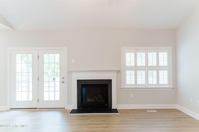 135 Live Oak Dr, Leland, NC 28451 - unfurnished living room featuring visible vents, wood finished floors, baseboards, and a fireplace with flush hearth