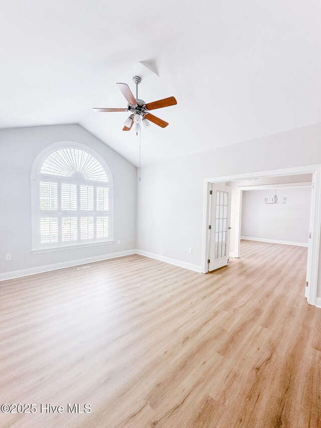 135 Live Oak Dr, Leland, NC 28451 - unfurnished living room with a ceiling fan, light wood-style floors, baseboards, and vaulted ceiling