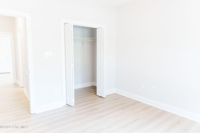 135 Live Oak Dr, Leland, NC 28451 - unfurnished bedroom with a closet, light wood-type flooring, and baseboards